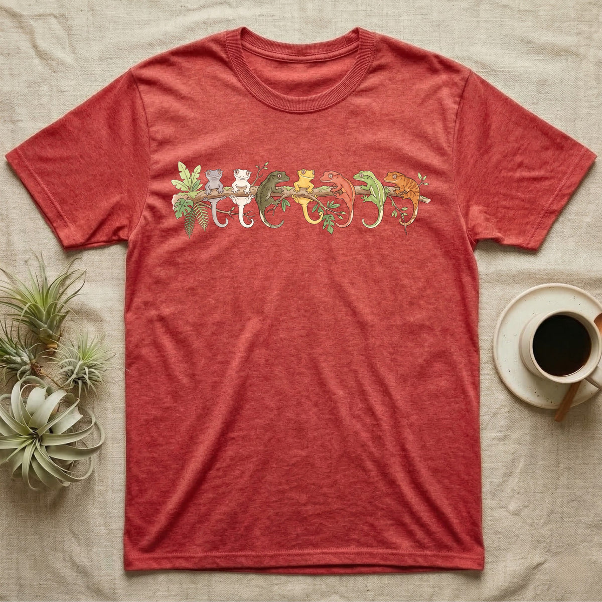 Crested Gecko Canopy Crew T-Shirt in Heather Red — Watercolor illustration of seven crested gecko colour morphs perched on a branch, dark grey T-shirt design.