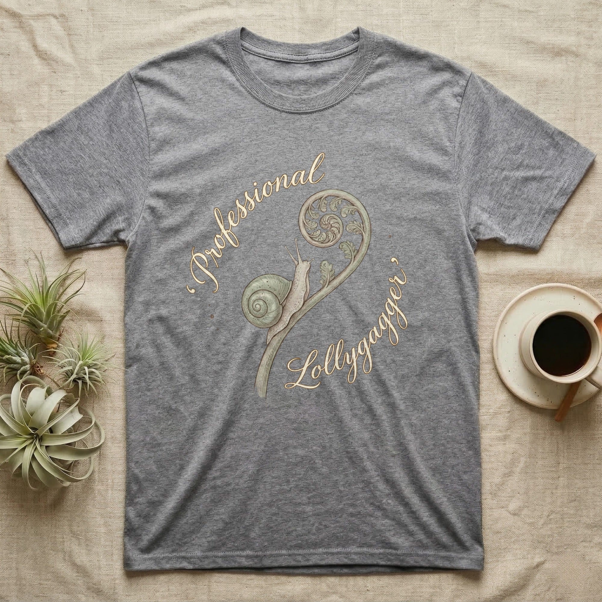 Grey t-shirt with a snail and fern design and "Professional Lollygagger" text.
