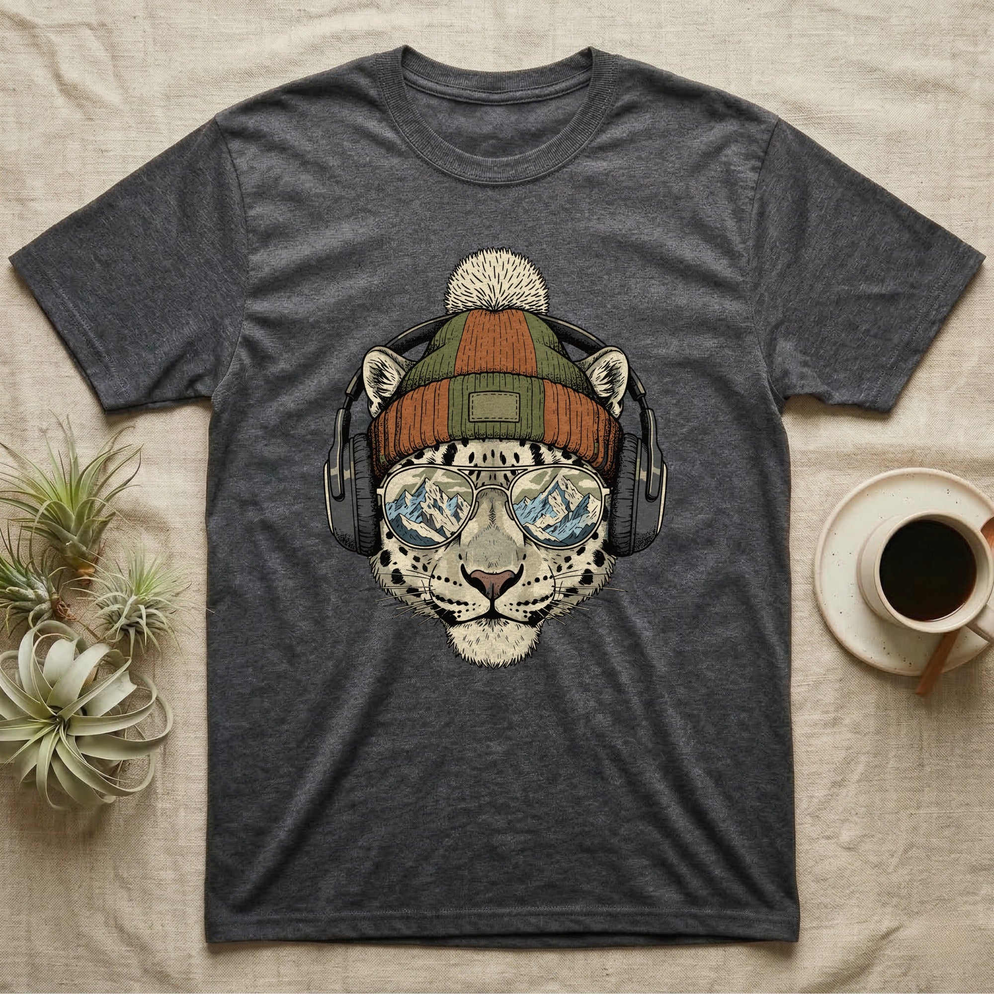 Dark grey t-shirt featuring a leopard wearing headphones and sunglasses with mountains reflected in lenses.