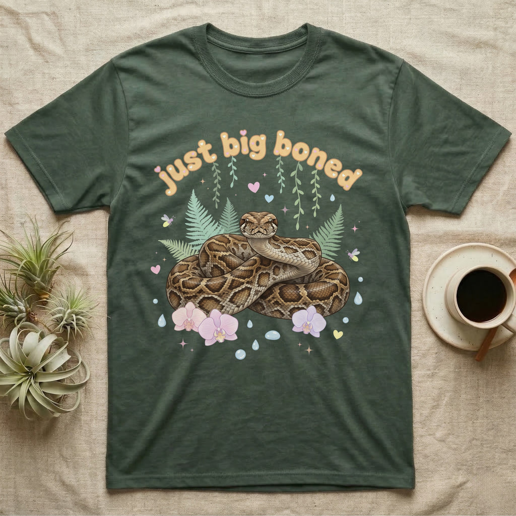 Burmese Python Baby T-Shirt in Military Green — Massive coiled Burmese python among pastel ferns and orchids under puffy butterscotch bubble text "just big boned".