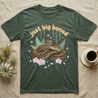Burmese Python Baby T-Shirt in Military Green — Massive coiled Burmese python among pastel ferns and orchids under puffy butterscotch bubble text "just big boned".