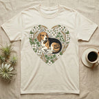 Beagle dog within a heart-shaped floral and wheat wreath on a cream t-shirt.