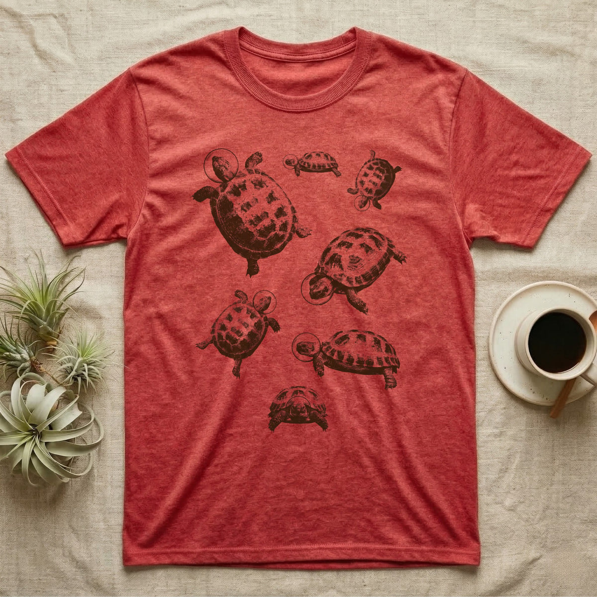 Russian Tortoise Space Helmets T-Shirt in Heather Red — One-ink screen print of seven Russian tortoises in rounded space helmets drifting at varied sizes.