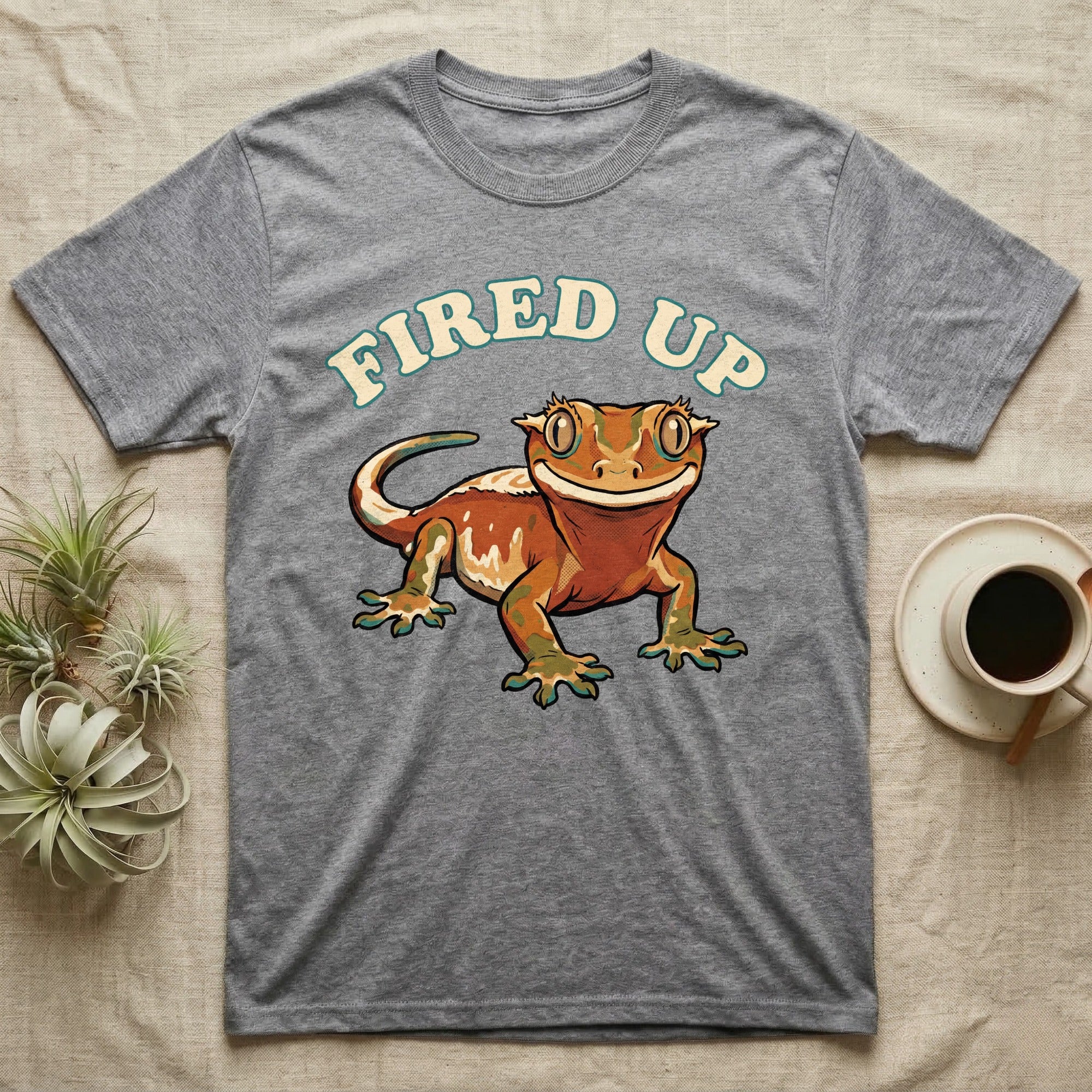 Fired Up Crested Gecko T-Shirt in Sport Grey — Retro 90s-style illustration of a fired-up crested gecko under a bold arc headline reading Fired Up.
