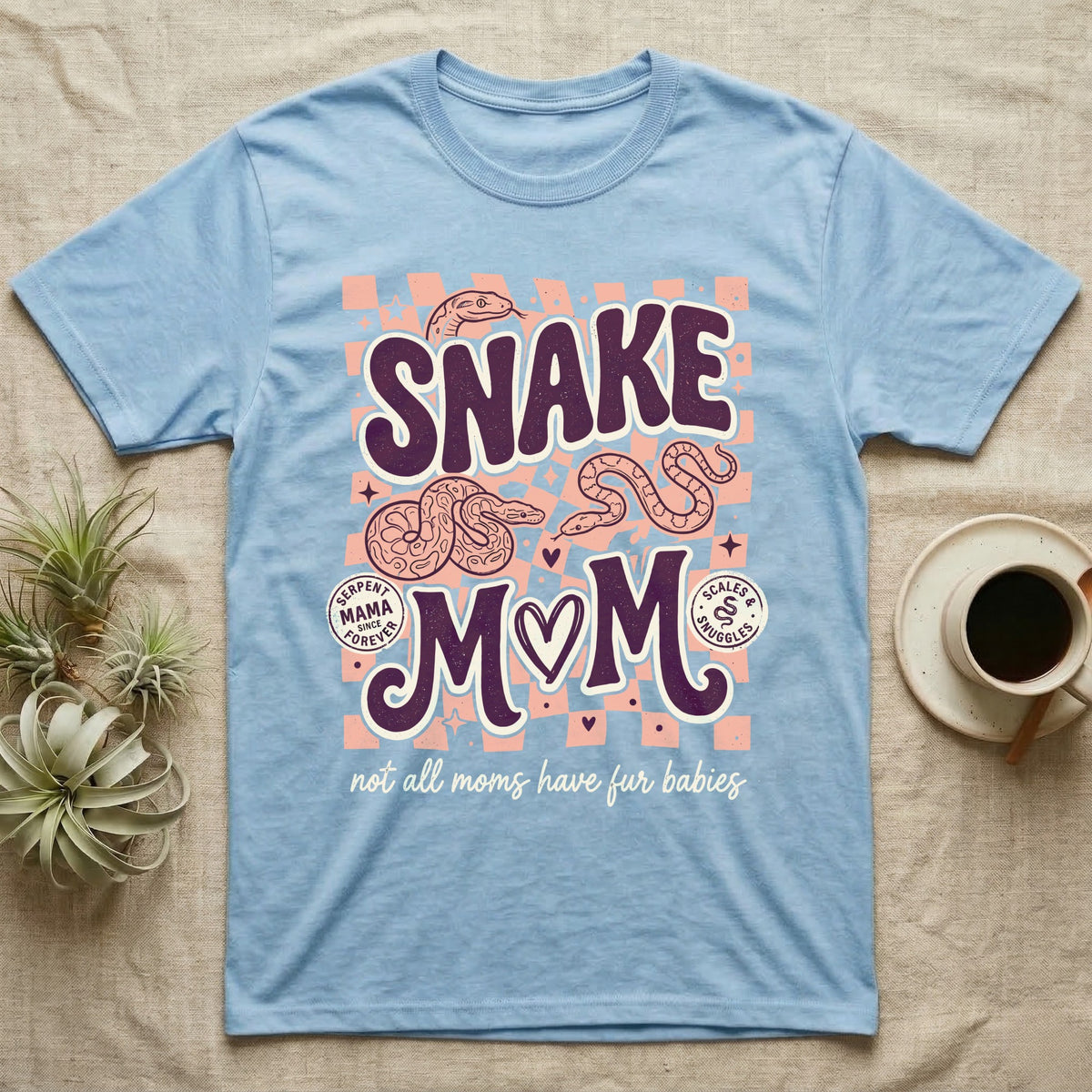 Light blue t-shirt with "Snake Mom" graphic, two snakes, and text.