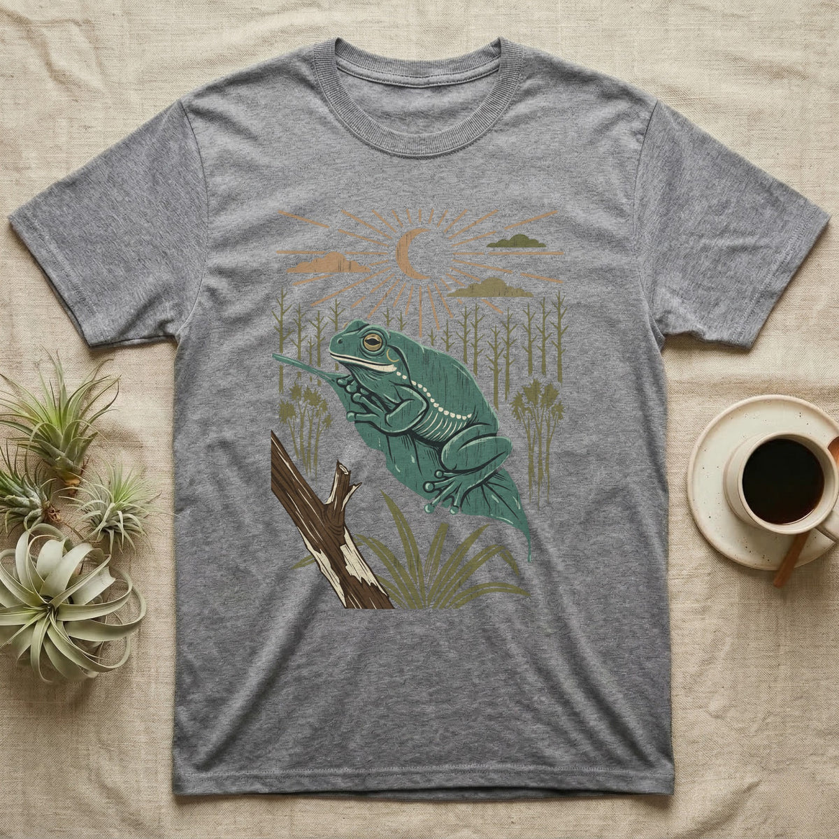 White's Tree Frog Home Range T-Shirt in Sport Grey — Woodcut-style illustration of a White's tree frog resting on a broad wet leaf with reed stems and a crescent moon behind, no on-shirt text.