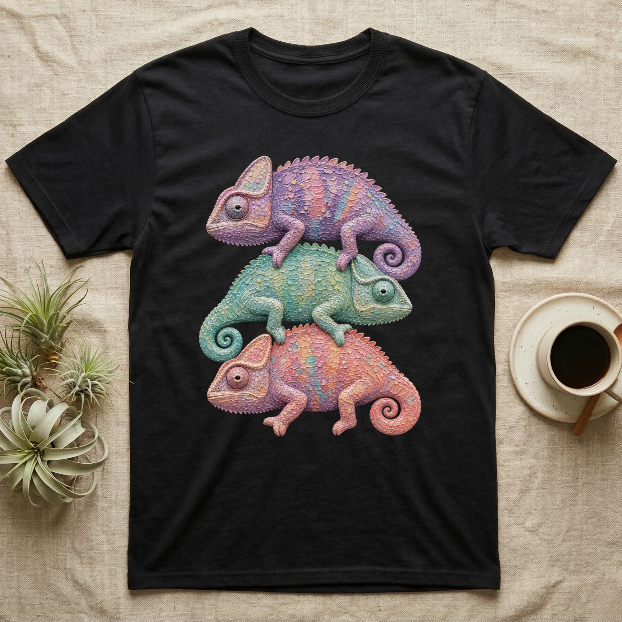 Three colorful chameleons stacked on a black t-shirt.