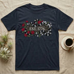 Kingsnake Floral 1776 T-Shirt in Navy — Black-and-white California kingsnake woven through roses and jasmine around a wooden sign reading Est. 1776.