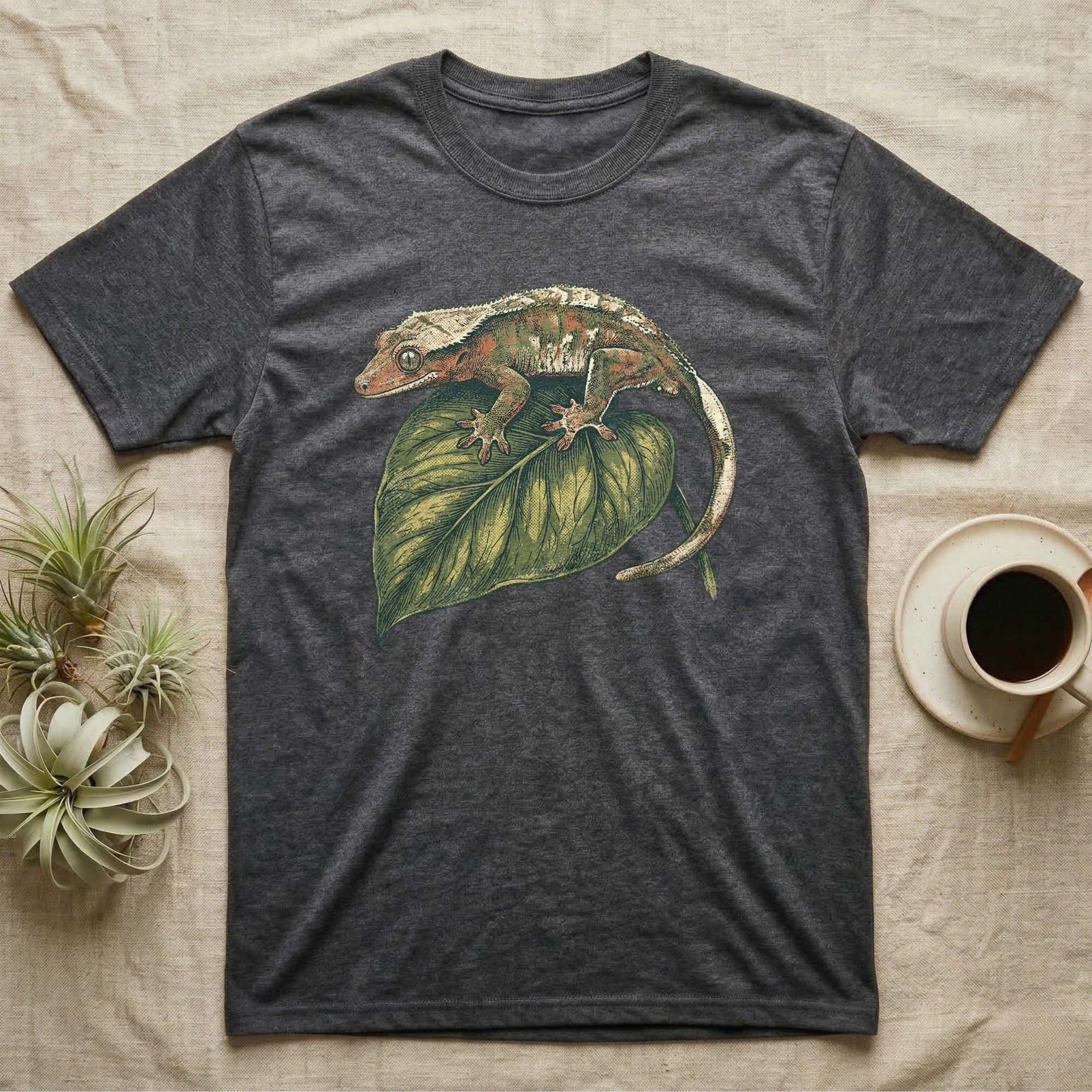 Dark gray t-shirt featuring a crested gecko illustration on a green leaf.