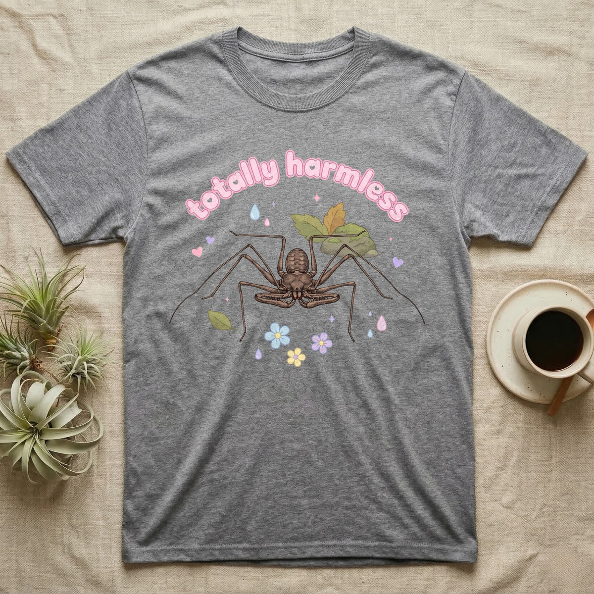 Tailless Whip Scorpion Baby T-Shirt in Sport Grey — Pastel tailless whip scorpion with long whip legs among leaves and blossoms, puffy pink wordmark "totally harmless" above.