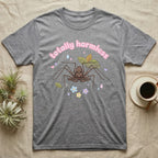 Tailless Whip Scorpion Baby T-Shirt in Sport Grey — Pastel tailless whip scorpion with long whip legs among leaves and blossoms, puffy pink wordmark "totally harmless" above.