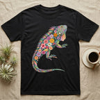 Green Iguana Floral Mosaic T-Shirt in Black — Watercolour green iguana climbing, its whole body built from painted hibiscus, dandelion and leaf shapes.
