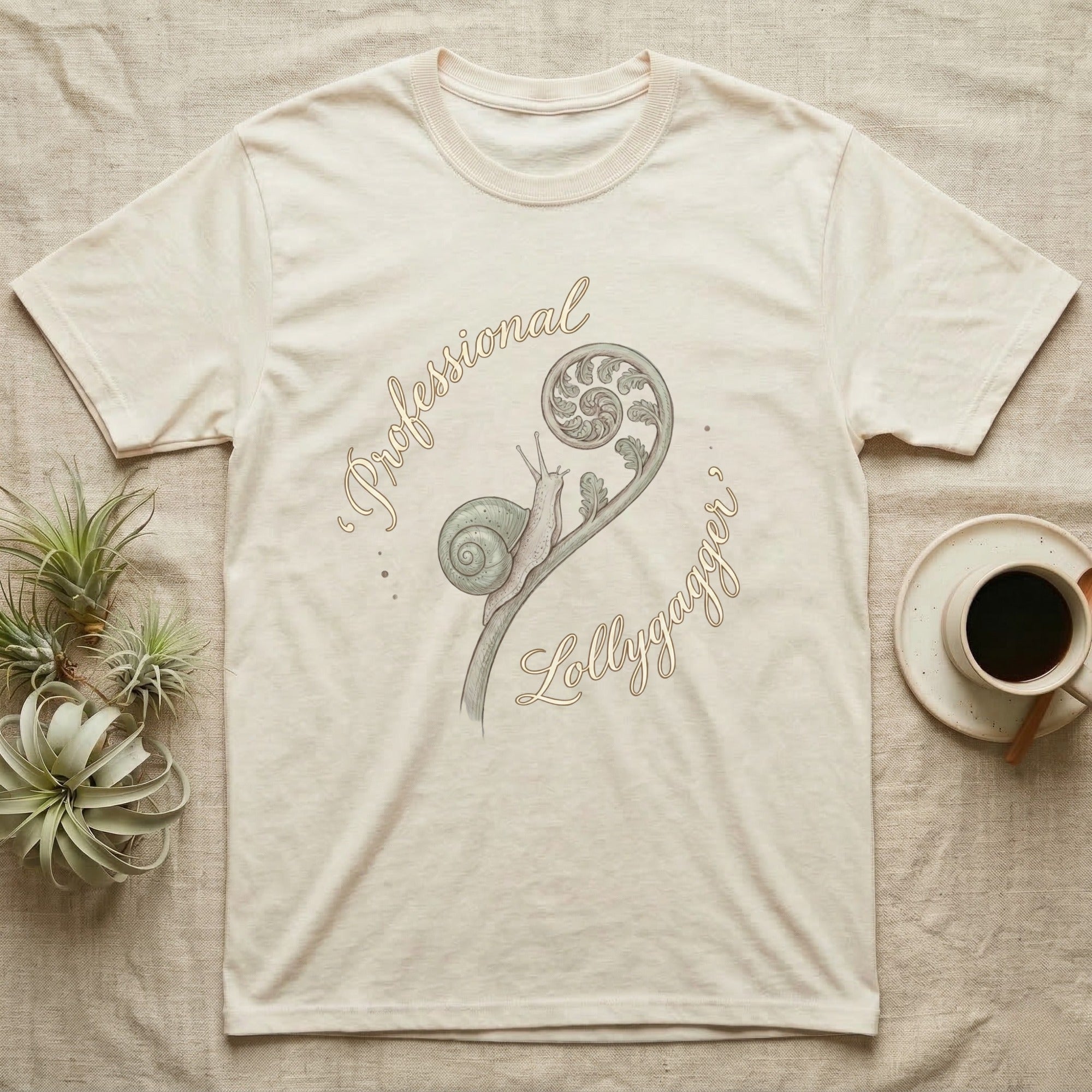 Cream t-shirt with "Professional Lollygagger" text and snail on fern graphic.