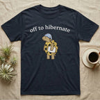 Hermann's Tortoise Hibernation T-Shirt in Navy — Minimal doodle of a Hermann's tortoise in a striped nightcap holding a pillow under the words off to hibernate