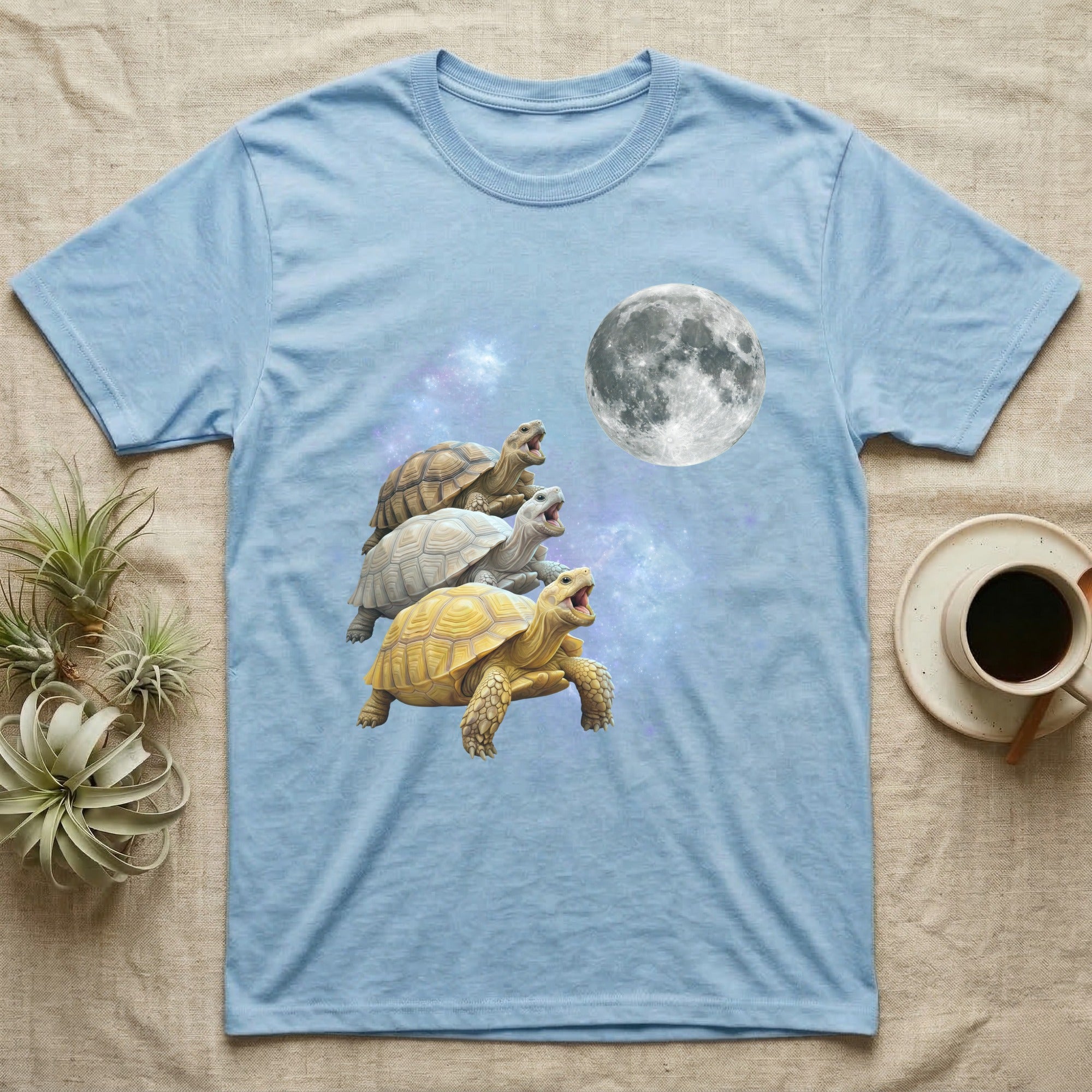 Sulcata Tortoise Moon Howl T-Shirt in Light Blue — Three Sulcata Tortoise colour morphs howling at a full moon over a nebula on a dark grey t-shirt.