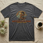 Dark gray t-shirt featuring a cowboy boot entwined with a snake and desert plants.