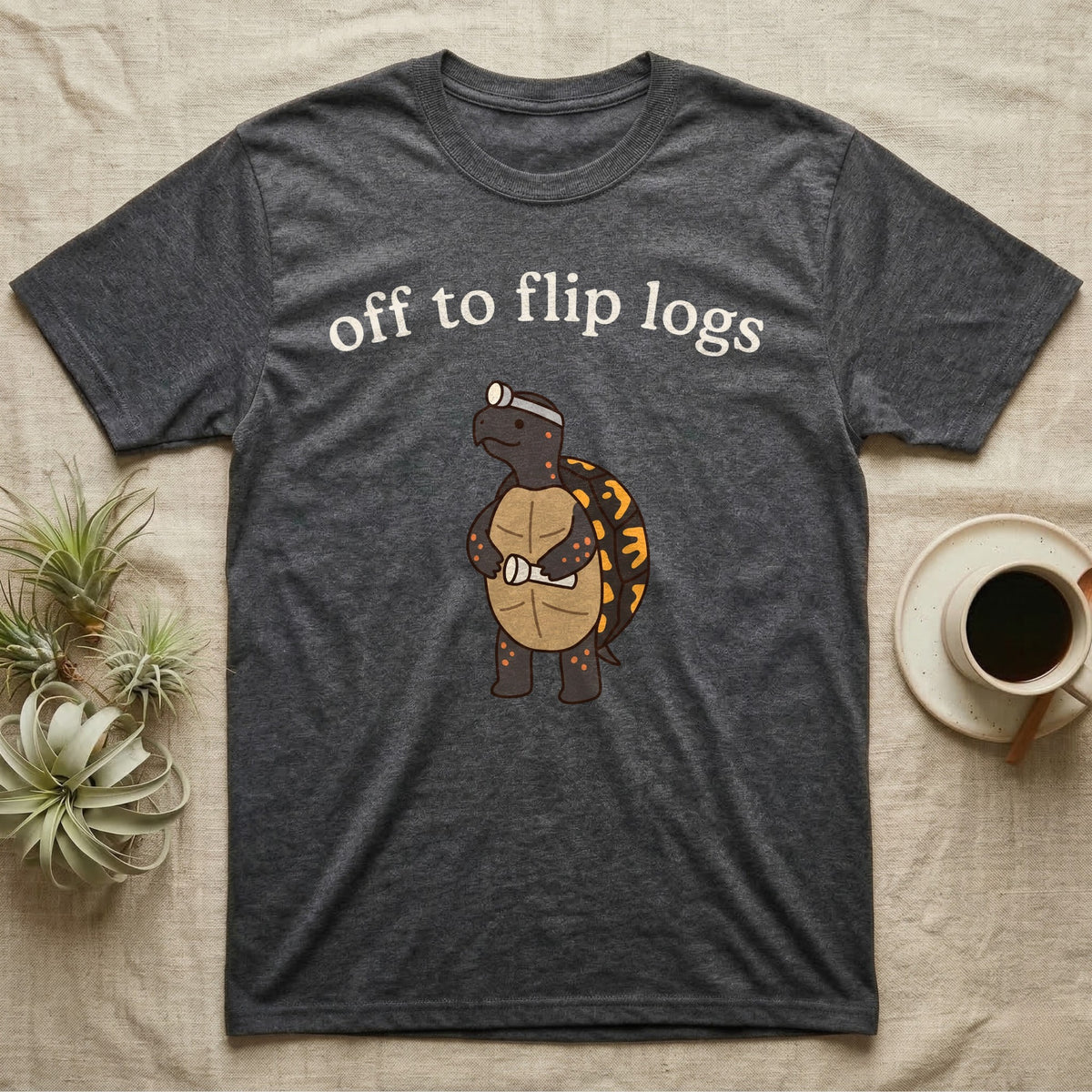 Box Turtle Herping T-Shirt in Dark Heather — Minimal doodle of an eastern box turtle standing upright in a headlamp holding a flashlight, under the words off to flip logs