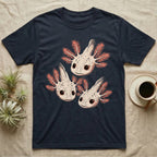 Vintage comic screen-print illustration of three axolotls clustered together with coral feathery gills and sparkling star-highlighted eyes, graphic-only, no text. — shown on a Navy tee.