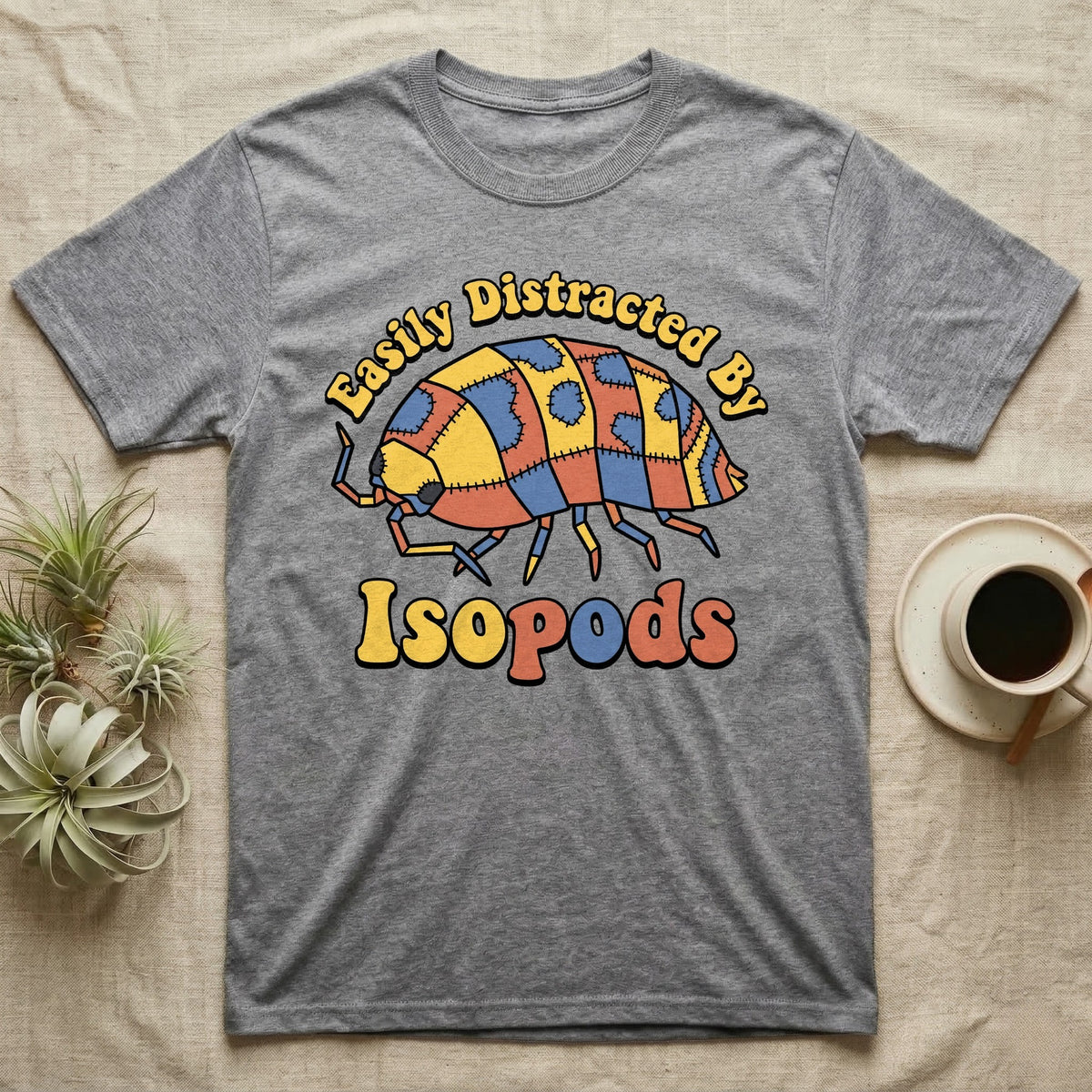Dairy Cow Isopod Patchwork T-Shirt in Sport Grey — Quilt-patchwork dairy cow isopod in mustard and denim under retro "Easily Distracted By Isopods" text.