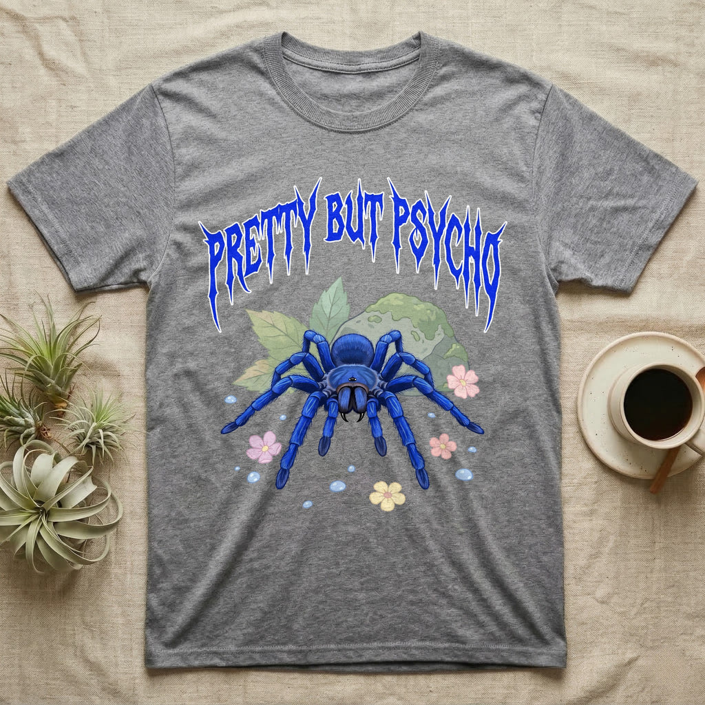 Cobalt Blue Tarantula Feral T-Shirt in Sport Grey — Cobalt blue tarantula with electric-blue legs under jagged cobalt metal text PRETTY BUT PSYCHO with pastel blossoms