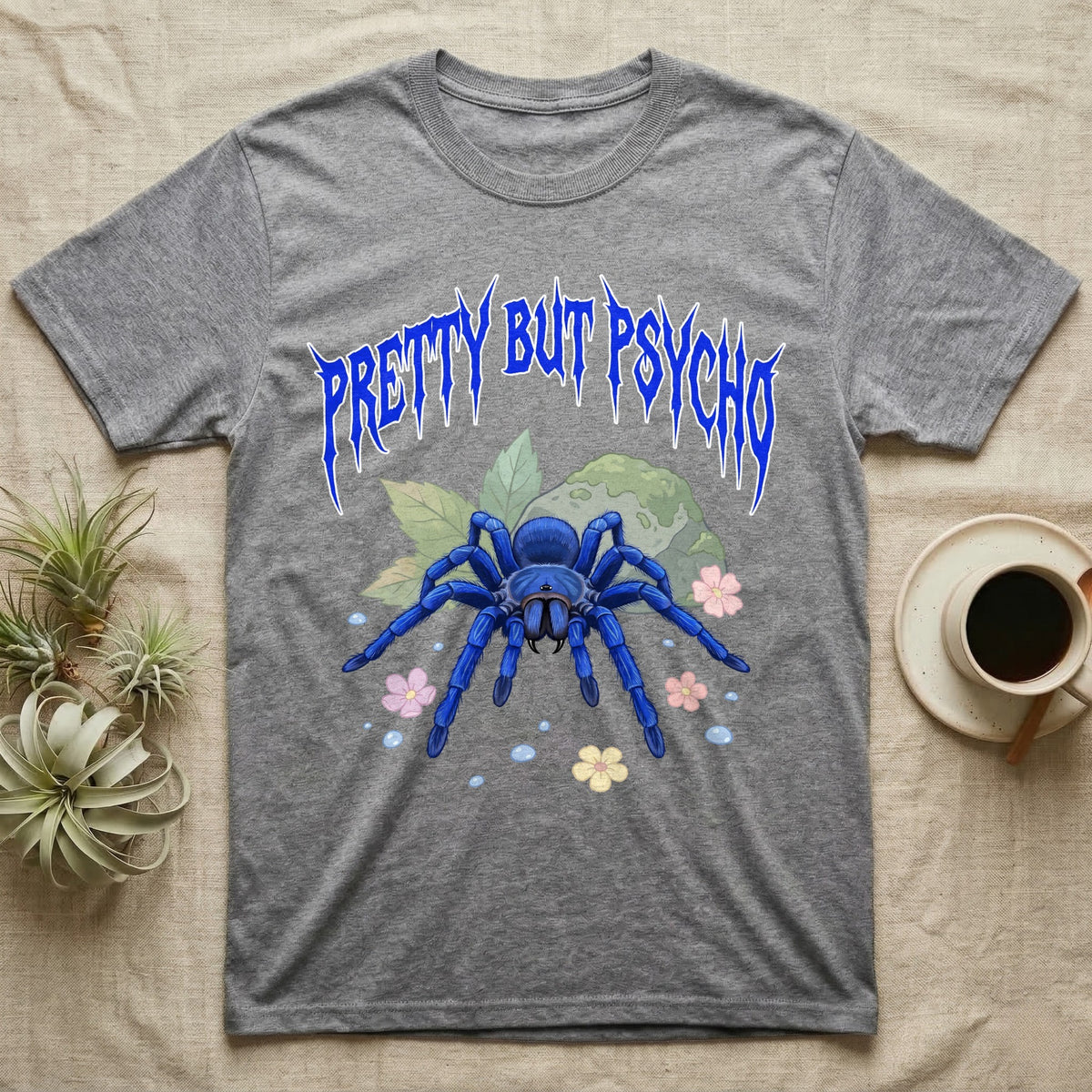 Cobalt Blue Tarantula Feral T-Shirt in Sport Grey — Cobalt blue tarantula with electric-blue legs under jagged cobalt metal text PRETTY BUT PSYCHO with pastel blossoms
