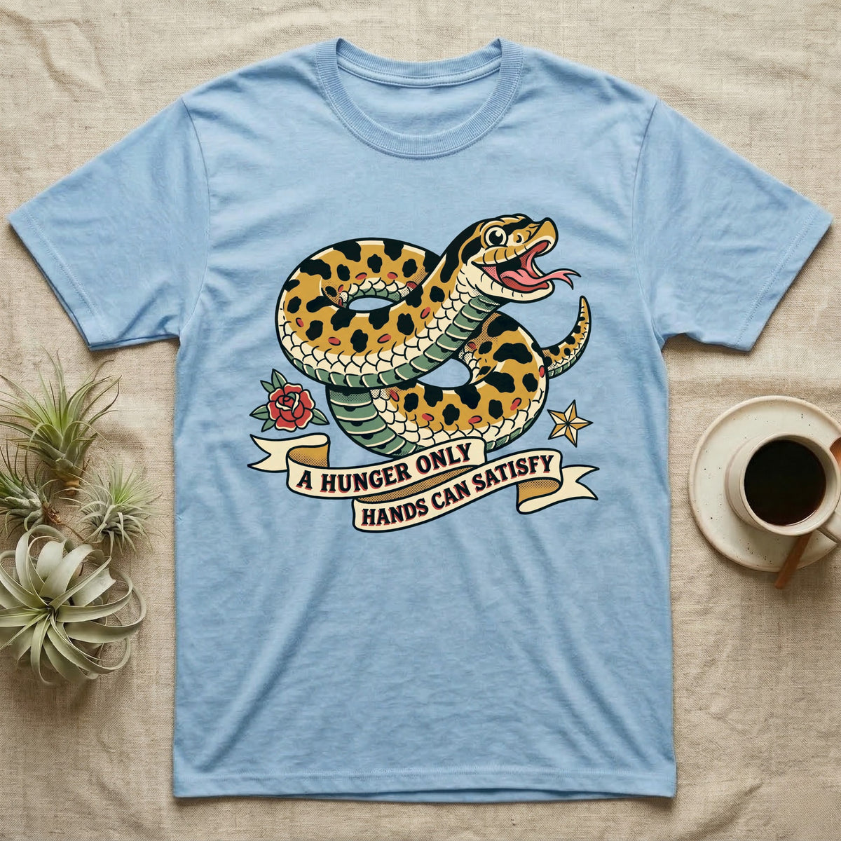 Hognose Hunger Flash T-Shirt in Light Blue — American-traditional tattoo-flash illustration of a hognose snake in a heroic coil with a banner reading the feeding-hunger line.