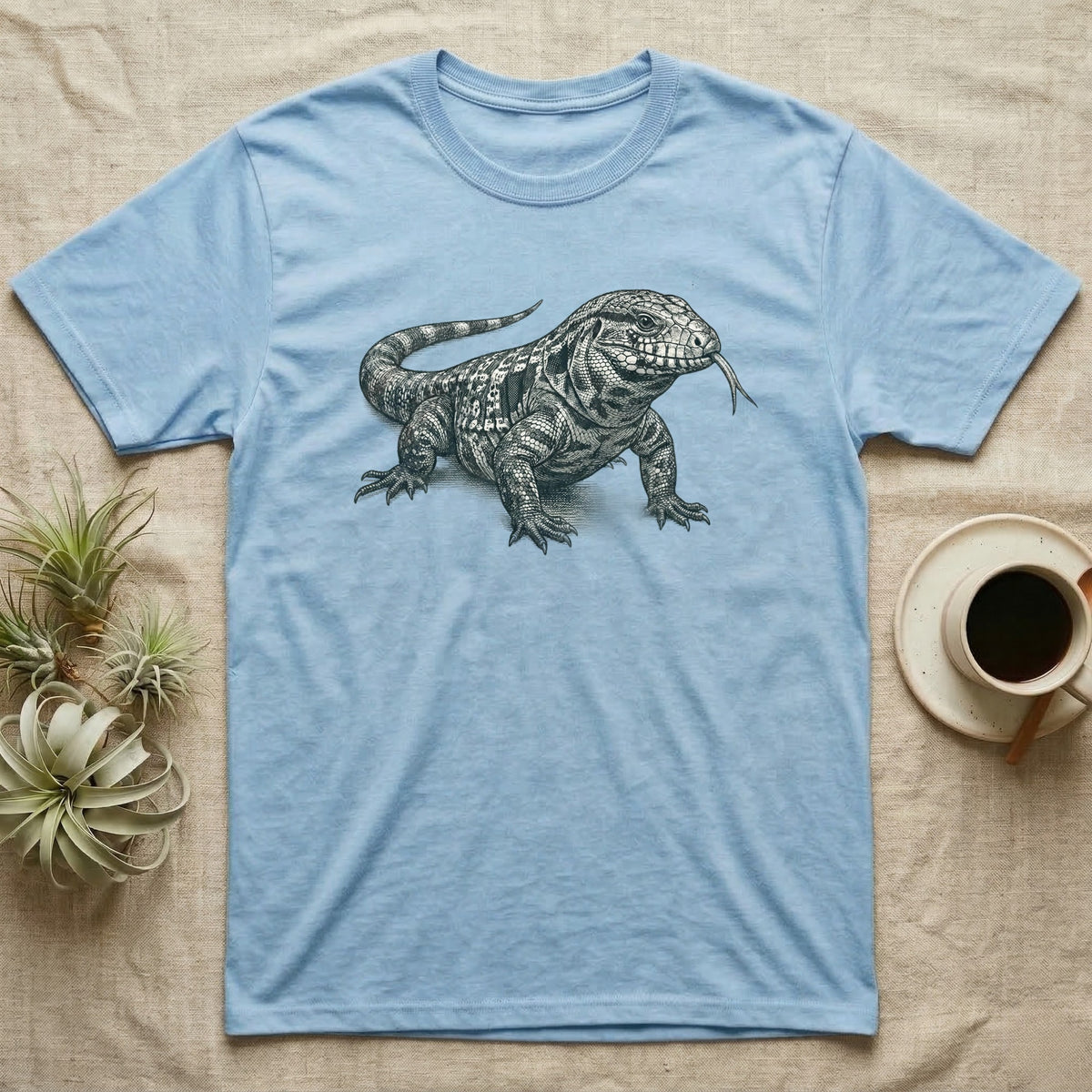 Light blue t-shirt with a detailed black and white drawing of a lizard.