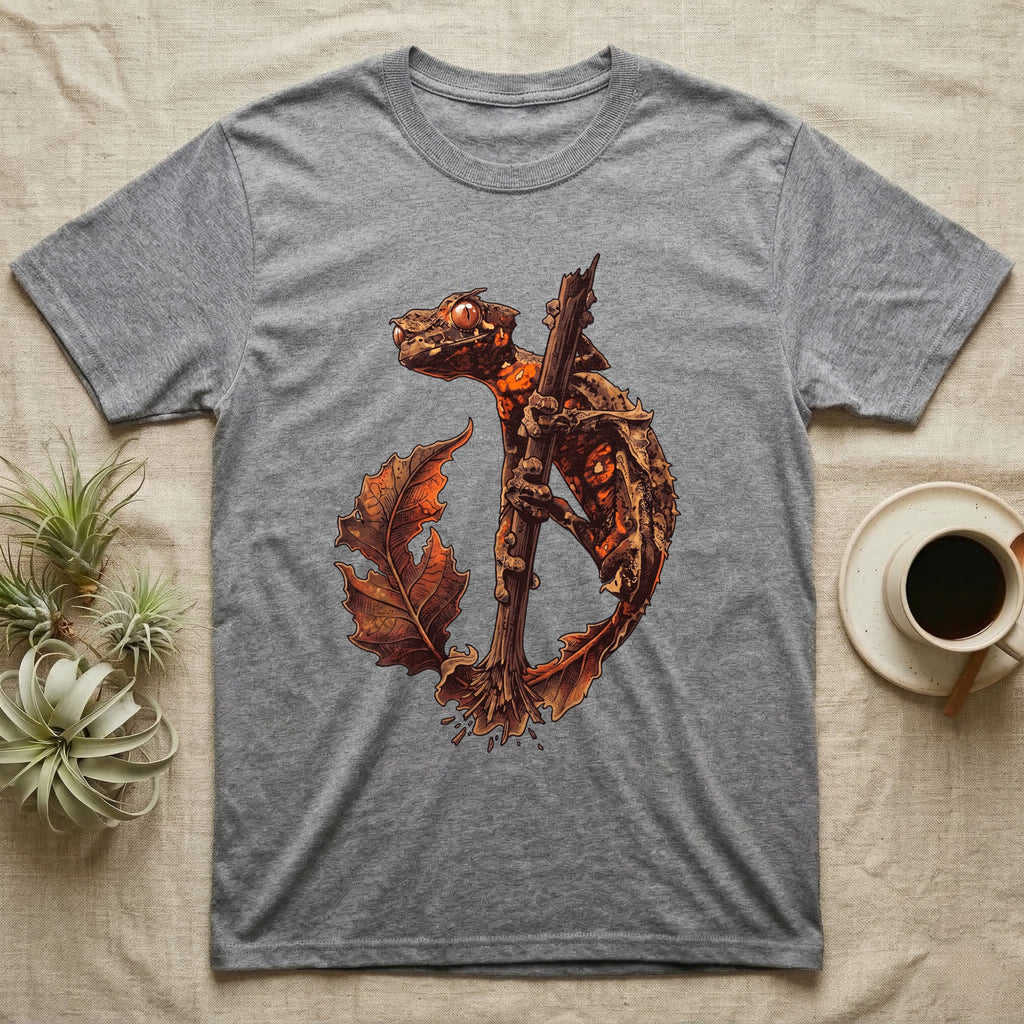 Vintage ink illustration of an eyelash leaf-tailed gecko clinging to a branch with its tail curled beside a serrated leaf, no on-shirt text. — shown on a Sport Grey tee.