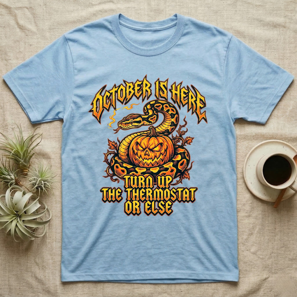 Ball Python October Thermostat T-Shirt in Light Blue — Metal-band style ball python coiled over a glowing jack-o'-lantern, "October Is Here, Turn Up the Thermostat Or Else."