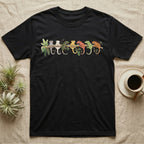 Crested Gecko Canopy Crew T-Shirt in Black — Watercolor illustration of seven crested gecko colour morphs perched on a branch, dark grey T-shirt design.