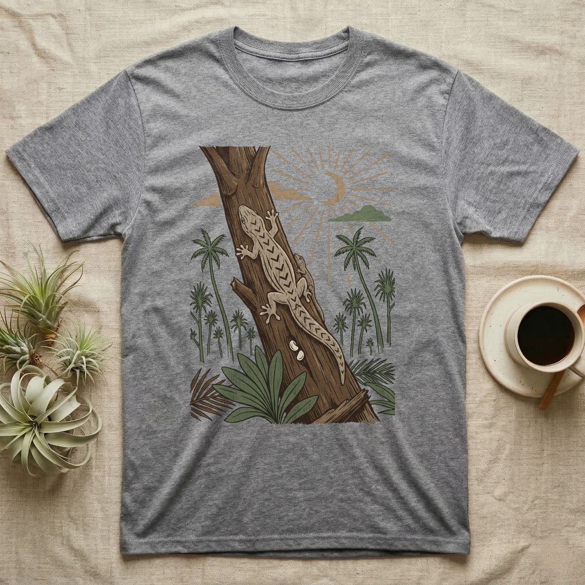 Mourning Gecko Home Range T-Shirt in Sport Grey — Woodcut-style illustration of two mourning geckos on a palm trunk with a pair of eggs in the bark and palms behind, no on-shirt text.