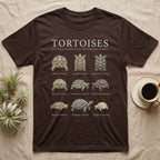 Tortoise Species Chart T-Shirt in Dark Chocolate — Watercolour chart of nine named tortoise species under a cream serif Tortoises title on charcoal grey