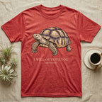 Sulcata Outlive You T-Shirt in Heather Red — Ukiyo-e woodblock illustration of a sulcata tortoise in profile with a deadpan serif caption about outliving you.
