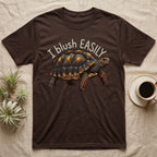 Red-Foot Tortoise Blush T-Shirt in Dark Chocolate — Red-footed tortoise with red-orange cheeks and legs walking under the curved words I blush EASILY