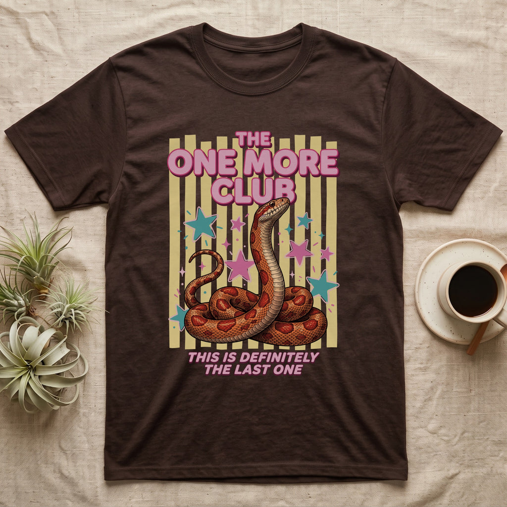 Corn Snake Club T-Shirt in Dark Chocolate — Engraved corn snake sitting deadpan under pink lettering The One More Club, with This is definitely the last one below, on yellow stripes