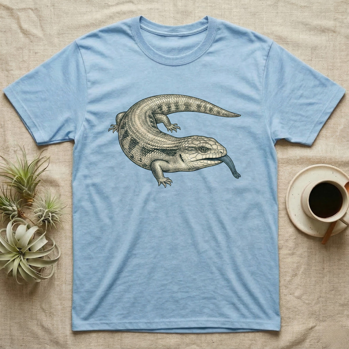 Light blue t-shirt with a sketch of a lizard with its tongue out.