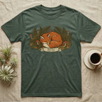 T-shirt with a sleeping red fox surrounded by ferns and mushrooms.