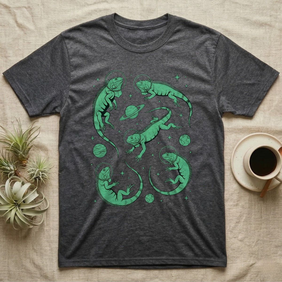 Green Iguana Cosmic T-Shirt in Dark Heather — Vintage screen-print illustration of green iguanas in astronaut helmets floating in space, cosmic emerald green monochromatic on dark background.