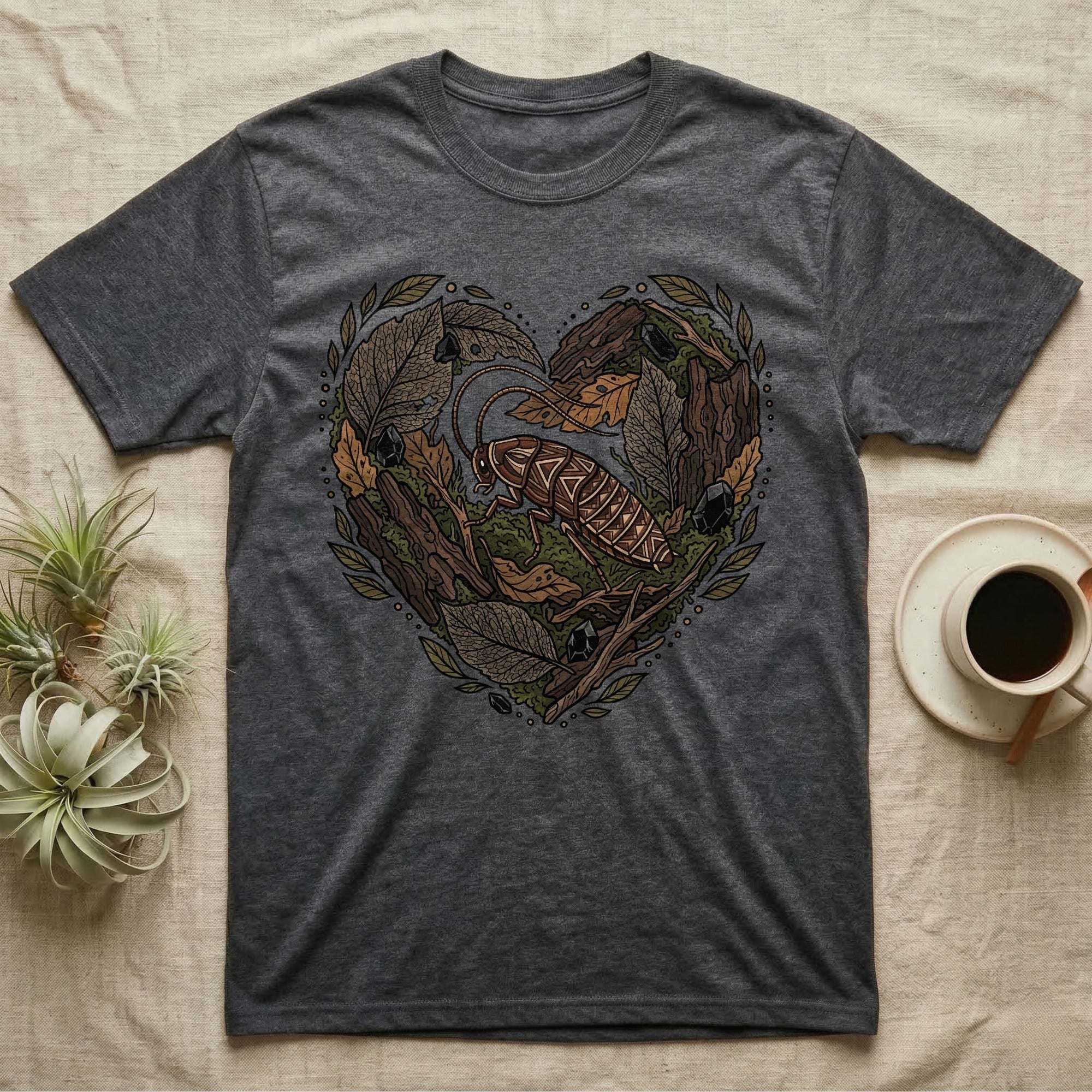 Dark grey t-shirt with heart-shaped forest graphic featuring a cockroach.