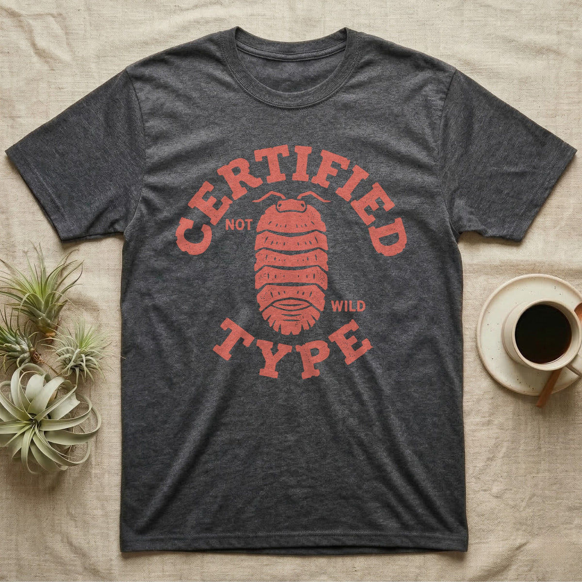 Isopod Certified Morph T-Shirt in Dark Heather — Carved block-print isopod seen from above inside a ring of terracotta lettering reading CERTIFIED NOT WILD TYPE.