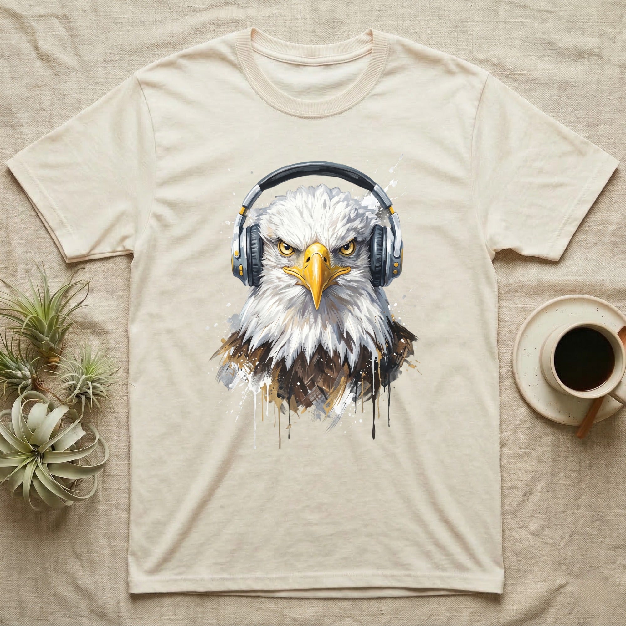 Eagle head with headphones graphic on a cream t-shirt.
