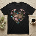 Black t-shirt with heart-shaped floral and gemstone cat graphic.