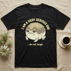 Black t-shirt with grumpy frog saying "I am a very serious orb...do not laugh."