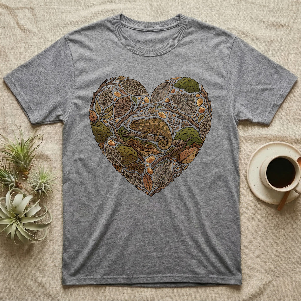 Grey t-shirt with a heart-shaped design featuring a chameleon among leaves and acorns.