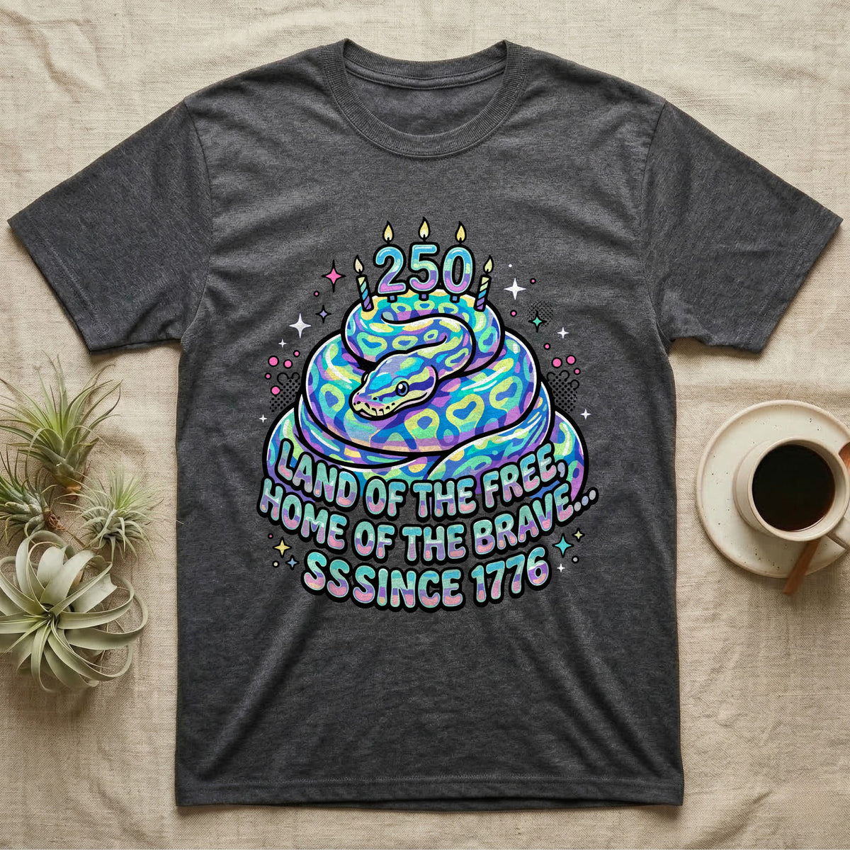 Ball Python Birthday Cake T-Shirt in Dark Heather — Y2K pastel ball python coiled as a birthday cake with 250 candles and bubble text Land of the Free, Sssince 1776.