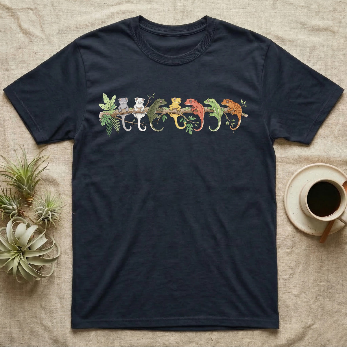Crested Gecko Canopy Crew T-Shirt in Navy — Watercolor illustration of seven crested gecko colour morphs perched on a branch, dark grey T-shirt design.