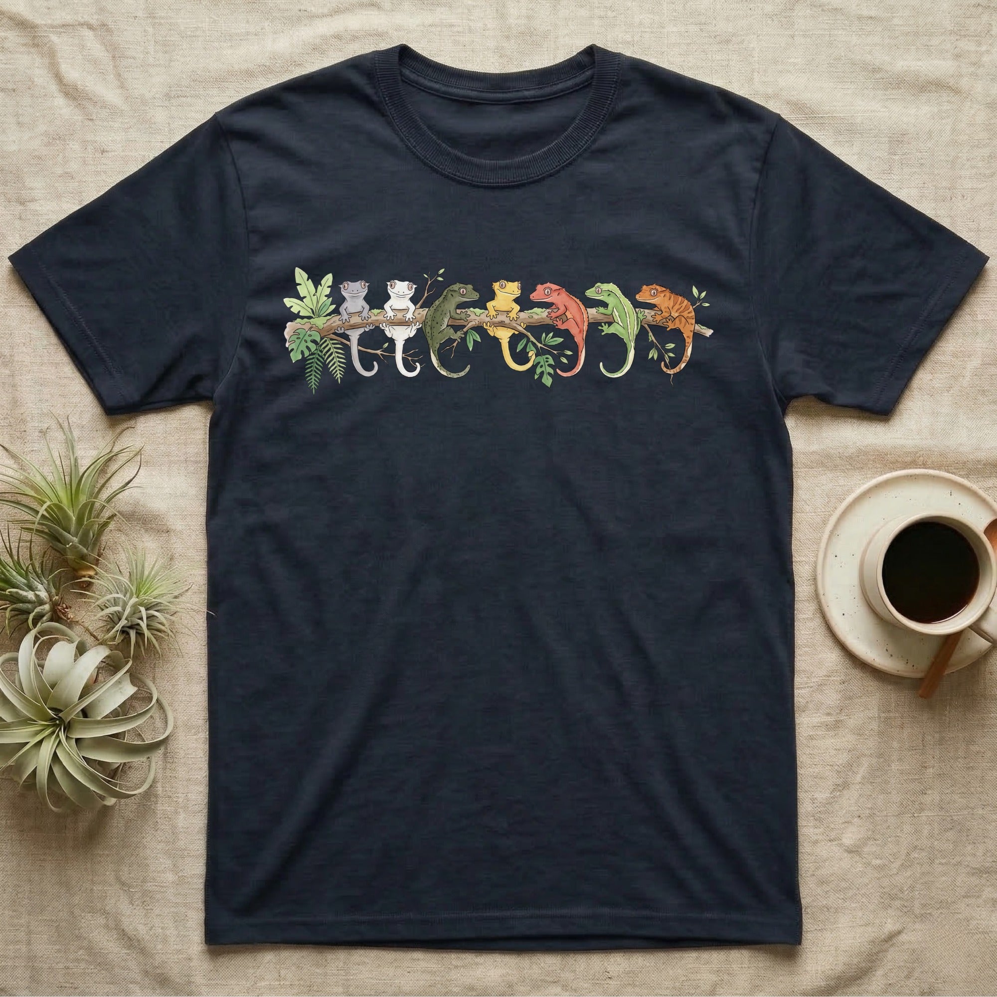 Crested Gecko Canopy Crew T-Shirt in Navy — Watercolor illustration of seven crested gecko colour morphs perched on a branch, dark grey T-shirt design.