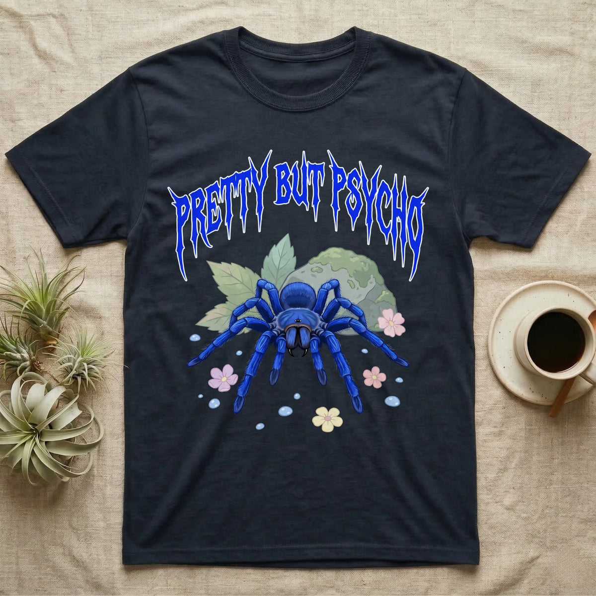 Cobalt Blue Tarantula Feral T-Shirt in Navy — Cobalt blue tarantula with electric-blue legs under jagged cobalt metal text PRETTY BUT PSYCHO with pastel blossoms