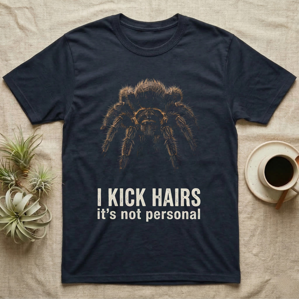 Deadpan photographic mugshot of a curly hair tarantula facing the camera above the distressed text I Kick Hairs, it's not personal. — shown on a Navy tee.