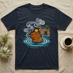 Capybara relaxing in hot springs with orange on head, steam, and trees.
